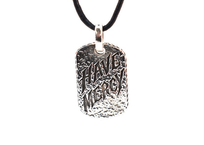 Have Mercy pendant on black leather cord, slightly angled front view showing hammered texture