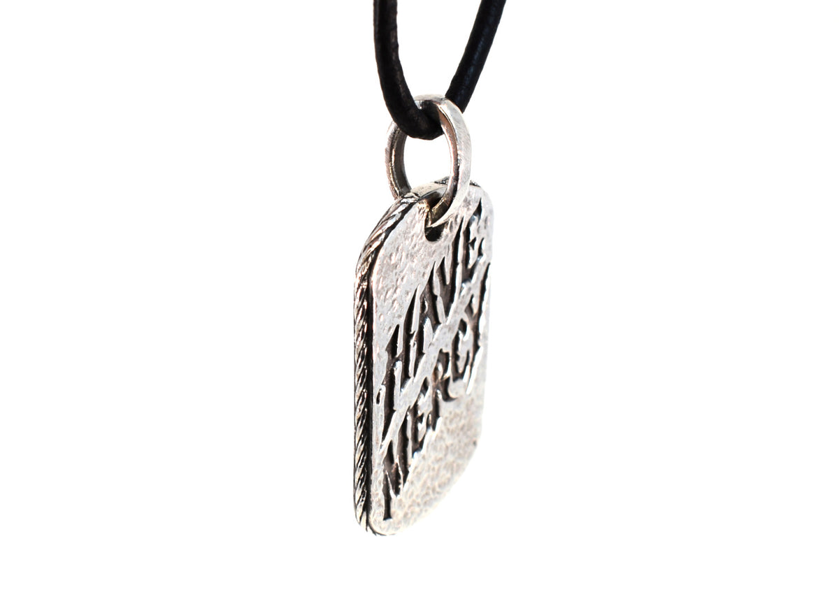 Side angle of Have Mercy pendant showing rope-style edge and thickness