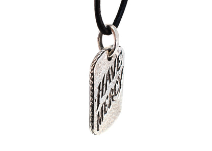 Side angle of Have Mercy pendant showing rope-style edge and thickness